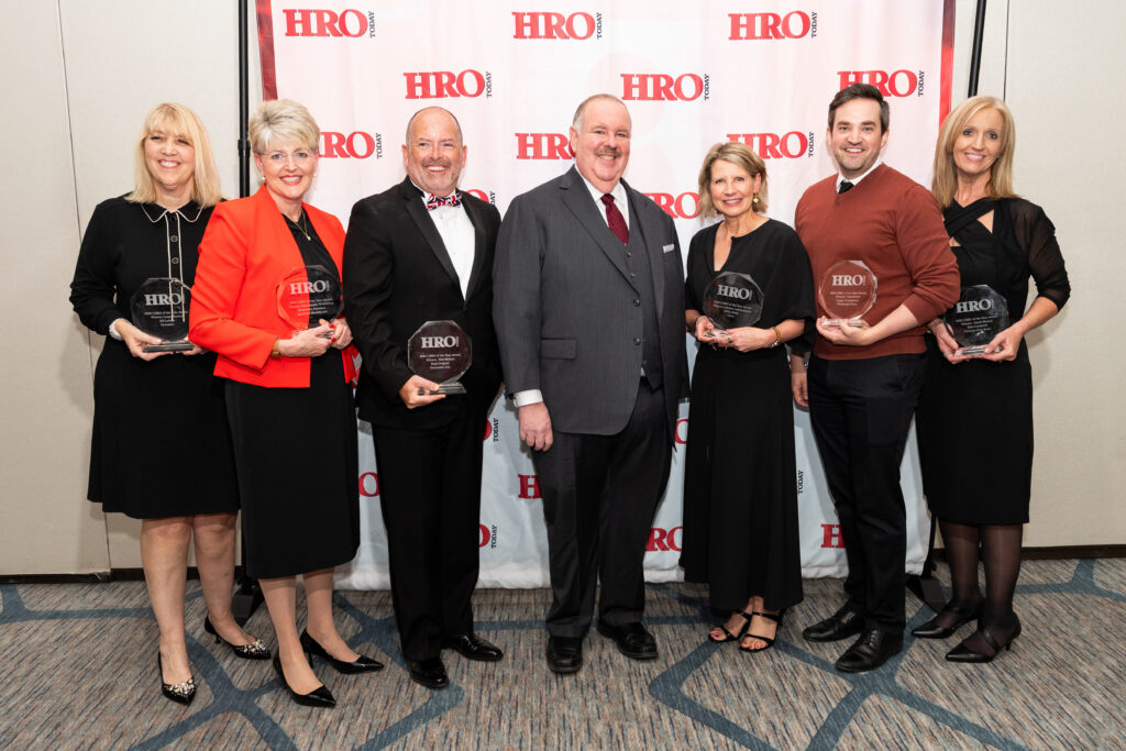 The 2026 CHRO of the Year Award Winners. (From Left: Jill Larsen, Synopsys; Rosemary Sheehan, Hartford HealthCare; Paul Gregory, Securonix; Elliot Clark, HRO Today; Kelly Jones, Cisco; Logan Carmichael, Pittsburgh Water; Tina Campbell, Citizens First Bank)